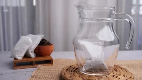 Serving tea with tea bags in big glass jar Stock Footage 274244800