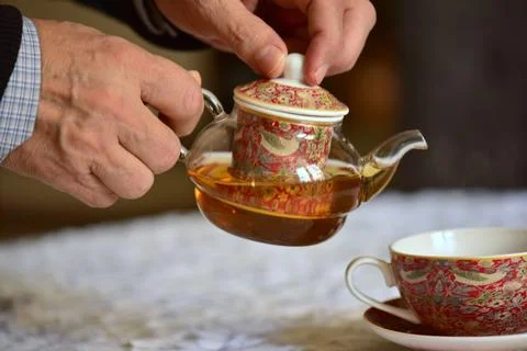 Serving tea. Tea pot and cup of tea Stock Photos