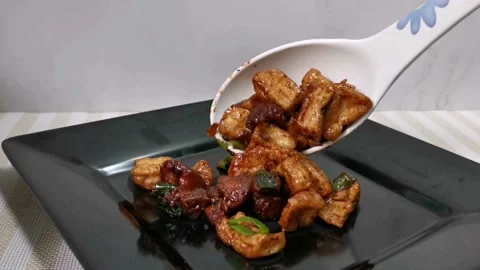 Serving Tofu and Pork Cubes with Oyster Sauce in a Plate Stock Footage 235499083