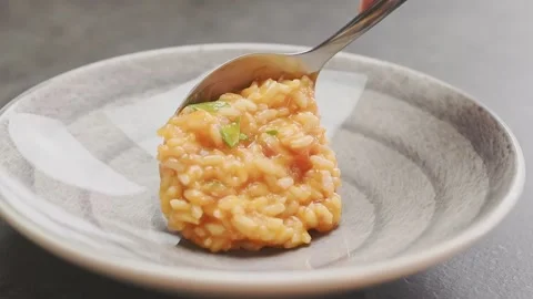 Serving tomato risotto on a plate. Stock Footage 159399571