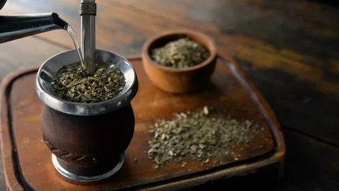 Serving traditional Argentinian yerba mate tea in a calabash gourd Stock-Footage 144350799