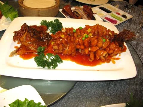 Serving tray with fish head on it in asia Stock Photos