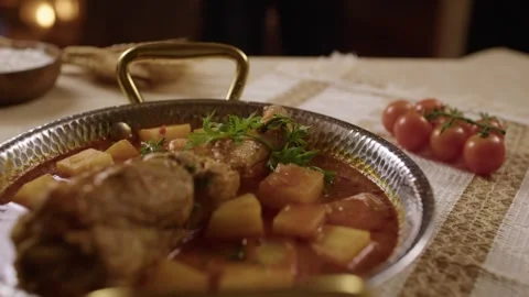 Serving Turkish Chicken Stew with Potatoes in Traditional Metal Pan on Rustic Stock Footage 345277217