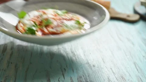 Serving the turkish eggs on the table. Video stock 207024078