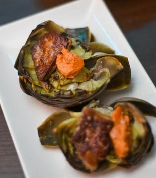Serving of two artichokes with various vegetables Stock Photos