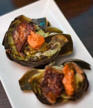 Serving of two artichokes with various vegetables Stock Photos