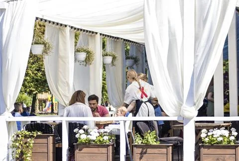 Serving visitors in a summer cafe Stock Photos