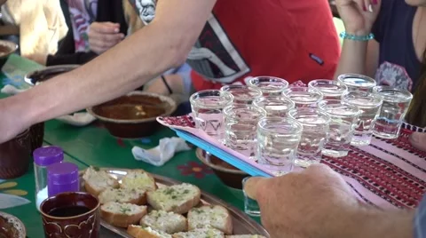 Serving vodka to group of tourists at the set table Stock Footage 64561915