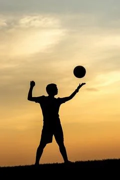 Serving the volleyball at sunset. Stock Photos