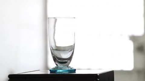 Serving water in a glass with white background Video stock 67729627