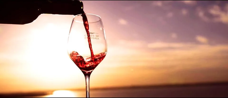 Serving wine in the light of a sunset Stock Photos