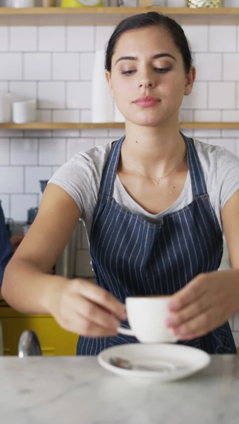 Serving, woman and face of server in cafe with coffee for customer order Stock Footage 334917712