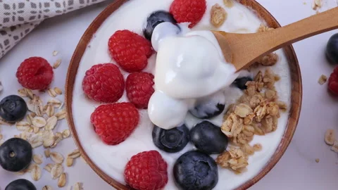 Serving yogurt with blueberry raspberry and oat flakes Stock Footage 201605425