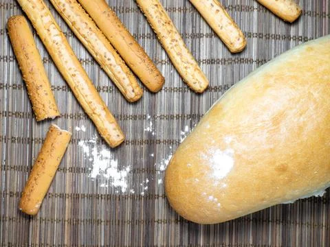 Sesame biscuits and bread on the table. Biscuits are elongated in the form of Stock Photos