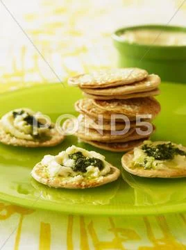 Sesame crackers with spread with soft cheese and pesto Stock Photos