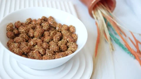 Sesame peanuts in a bowl on table Stock Footage 241471377