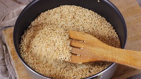 Sesame seeds close up. Loop rotation. Front of the camera rotates plate with Stock Footage 77194246