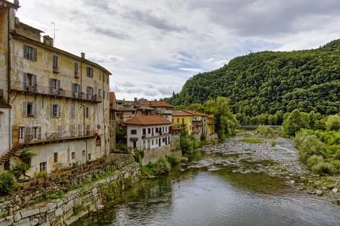 The Sesia River flows through the old town of the Alpine village of Varallo Stock Photos