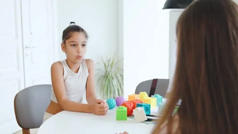 Session between speech therapist and child focused on letter recognition with Stock Footage 315539767