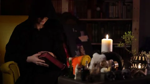 Session of black magic with a book by candle 스톡 동영상 133078525