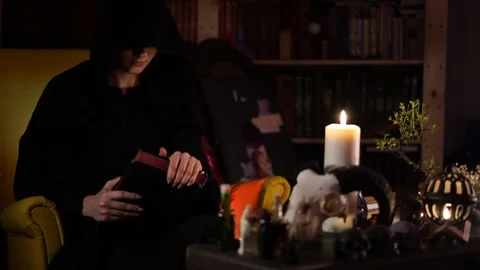 Session of black magic with a book by candle 스톡 동영상 133078602
