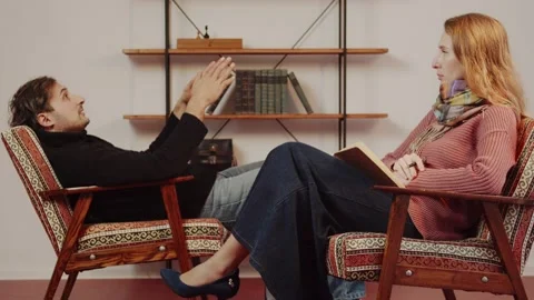 A session with a psychologist. A man talks about his problems to a psychologist Stock Footage 233000399