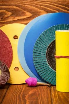Set of abrasive tools and multicolored sandpaper on wooden vintage background Stock Photos