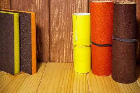 Set of abrasive tools and sandpaper on brown vintage wood background Stock Photos