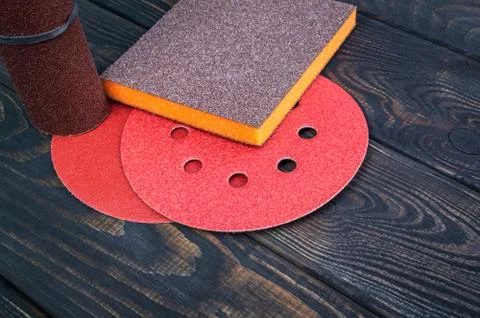 Set of abrasive tools and sandpaper different colors on black vintage wooden Stock Photos