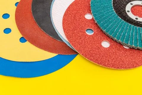 Set of abrasive tools and sandpaper on yellow background Stock Photos