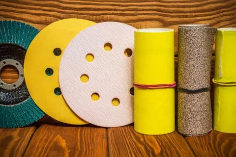 Set of abrasive tools and yellow sandpaper on vintage wooden background Stock Photos