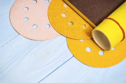 Set of abrasive tools and a yellow sandpaper on wooden blue boards Stock Photos