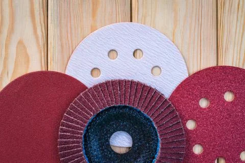 Set of abrasive tools different colors and sandpaper on wooden background Stock Photos