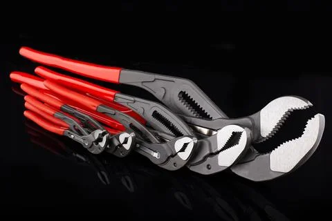 Set of Adjustable Wrenches with Red Handles Stock Photos