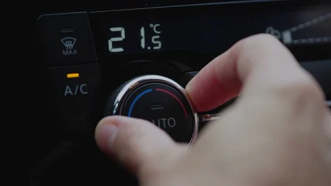 Set up air conditioner in the car. Hand turns air conditioner ring.  Stock Footage 142958262