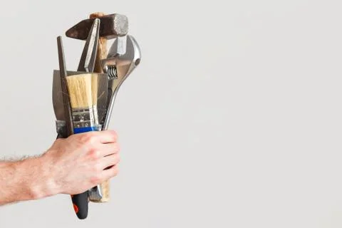 Set of all tools for repair at the same time in one hand of the master. Jack of Stock Photos