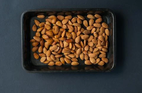 Set of almonds on black background. Different angles of popular tree nuts, he Stock Photos