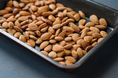 Set of almonds on black background. Different angles of popular tree nuts, he Stock Photos