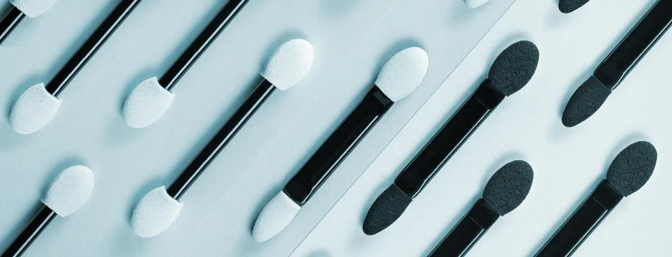 Set of applicators for applying shadows on blue background. Banner. Stock Photos