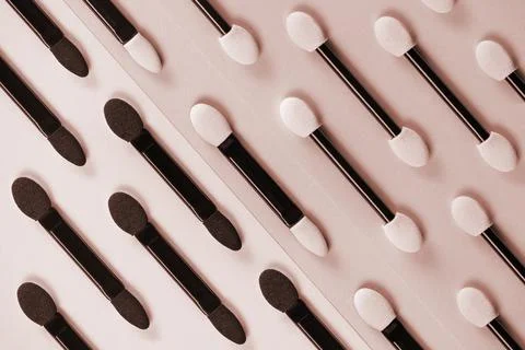 Set of applicators for applying shadows on pink background. Stock Photos
