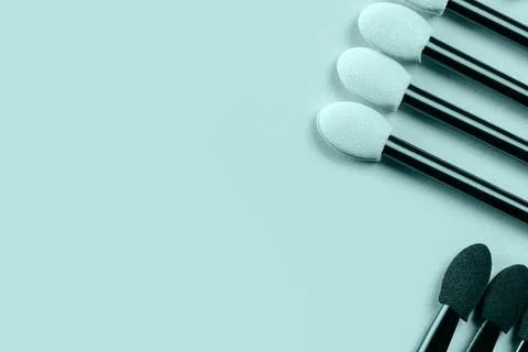 Set of applicators for shadows on blue background. Toned. Stock Photos