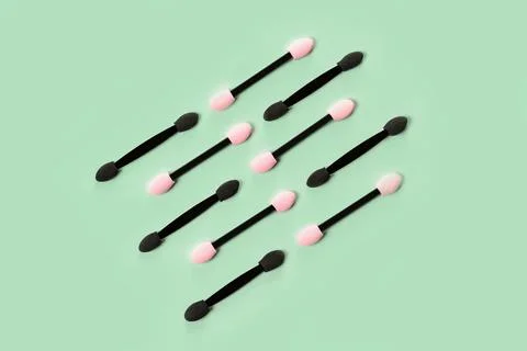 Set of applicators for shadows on green background. Stock Photos