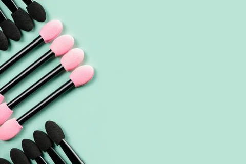 Set of applicators for shadows on green background. Stock Photos