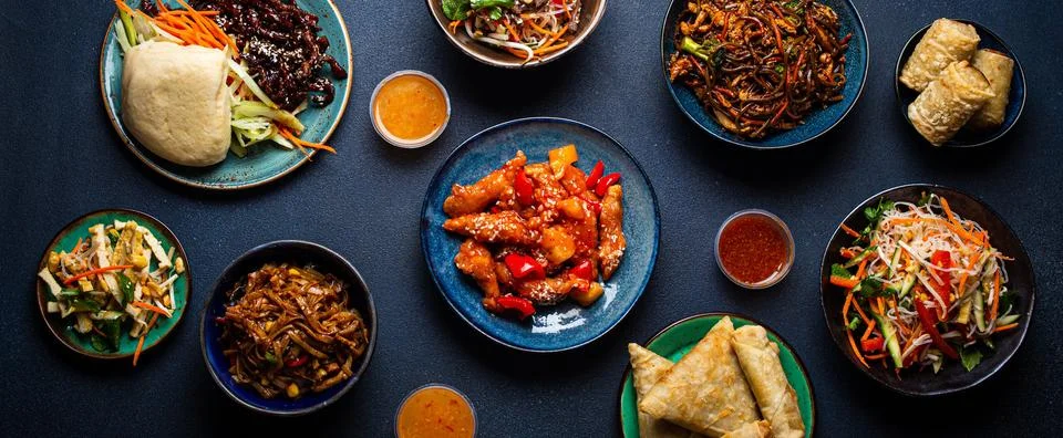 Set of assorted Chinese dishes on table sweet and sour chicken on plate fried Foto stock