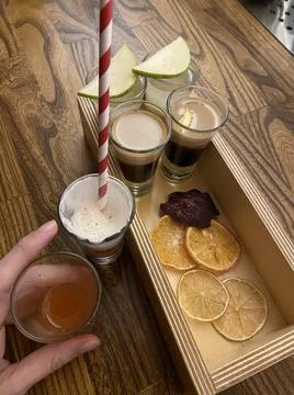 Set of assorted delicious alcoholic shots with dry fruits Stock Photos