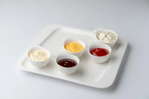 Set of assorted snack sauces isolated on white background: sour cream, mayo,  Stock Photos