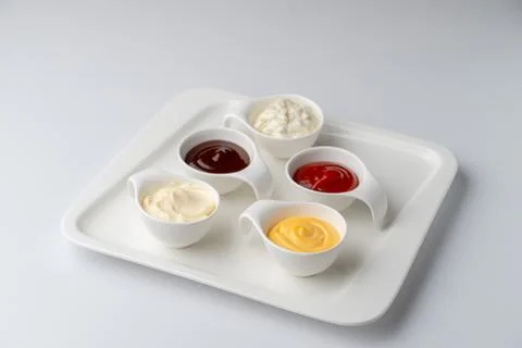 Set of assorted snack sauces isolated on white background: sour cream, mayo,  Foto stock