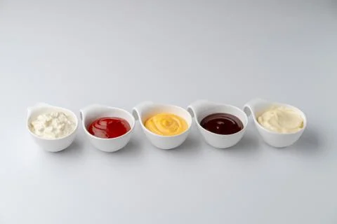 Set of assorted snack sauces isolated on white background: sour cream, mayo,  Stock Photos
