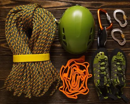 Set of basic climbing equipment on rough wood Stock Photos