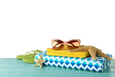 Set of beach accessories on table against white background. Space for text Foto stock